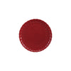 Red stoneware plate with scalloped edge on a white background