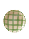 Round plate with green checkered pattern on a white background