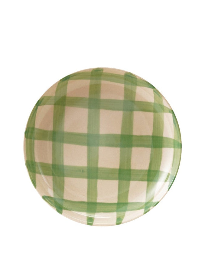Round plate with green checkered pattern on a white background