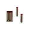 Green candles shaped like a wrapped present with red ribbons in a box on a white background