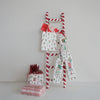 Decorative ladder with Christmas-themed gifts on a plain background