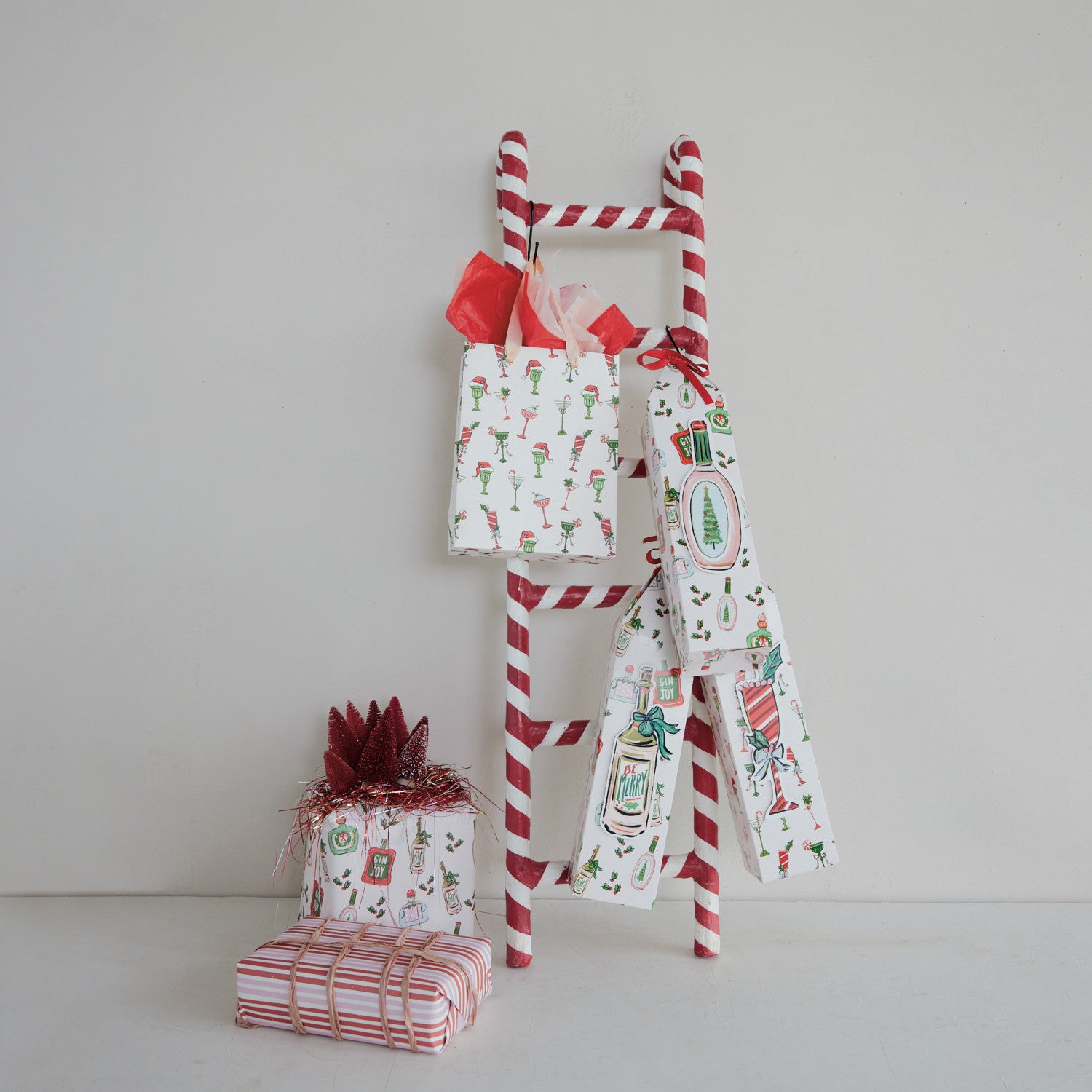 Decorative ladder with Christmas-themed gifts on a plain background