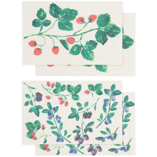 Two pop-up sponges with botanical patterns of berries and leaves on a white background.